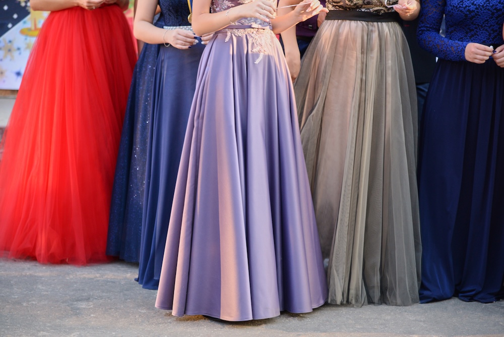 Young girls in long beautiful evening dresses, the lower part